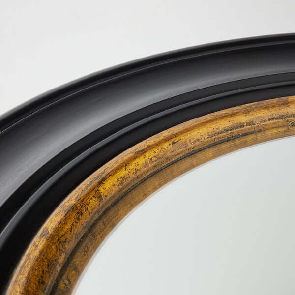 Close-up of the frame detail of Pooky - Marlon Convex Mirror - Black and Gold showcasing black and gold finishes.