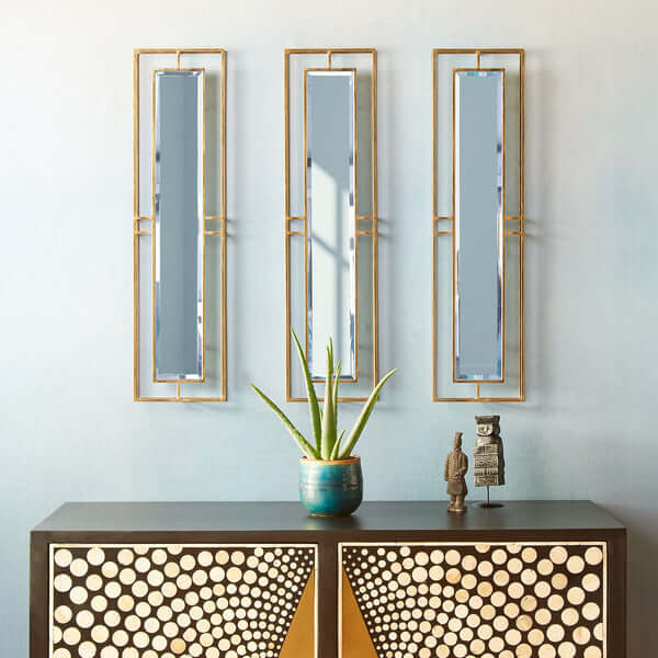 Pooky - Rectangular Necklace Link Mirror - Antique Gold hung in a stylish setting with a plant and decor.