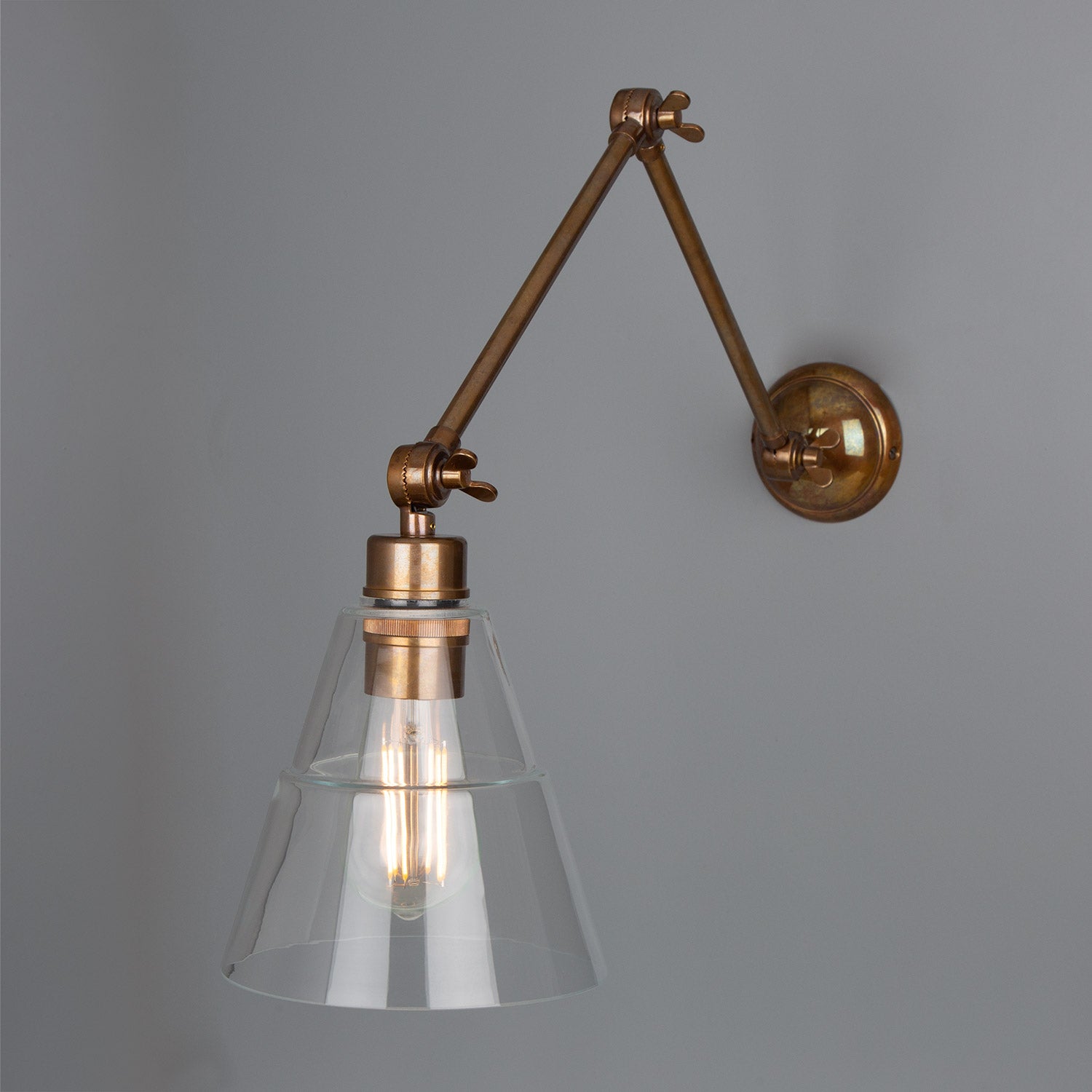 Mullan - Lyx Clear Glass Cone Adjustable Arm Wall Light - Antique Brass Finish