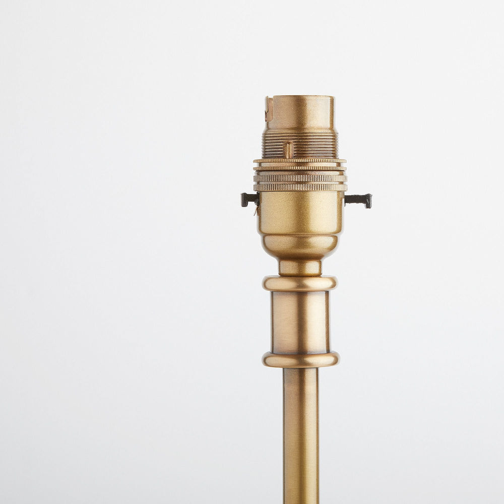 Detail of the bulb holder for the Pooky - Regular Pod Table Lamp Base - Antique Brass.