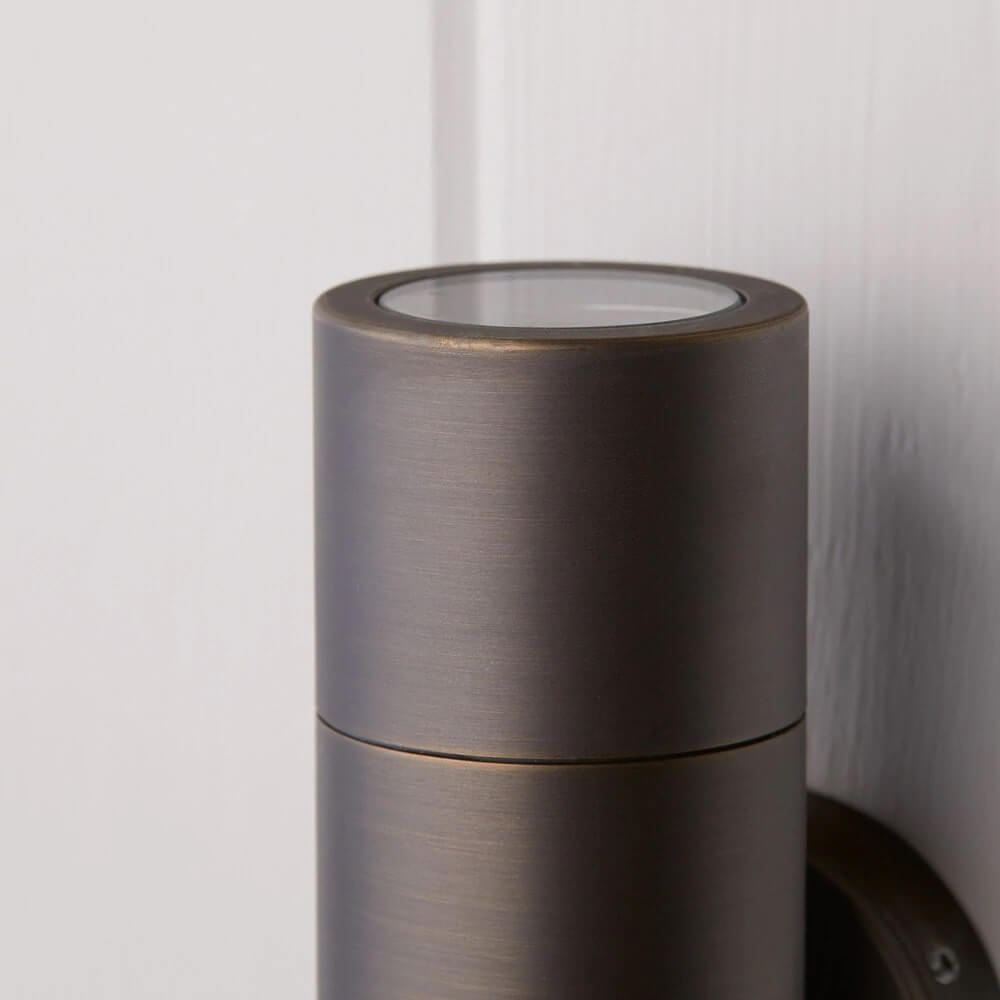 Pooky Portreath IP65 Up and Down Pillar wall light in Bronze close-up view showcasing its cylindrical design.