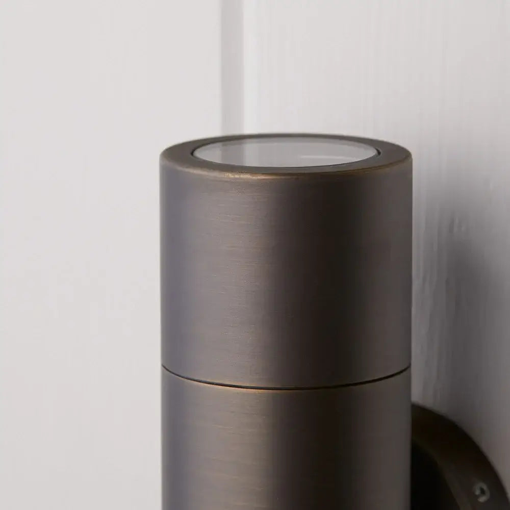 Pooky Portreath IP65 Up and Down Pillar wall light in Bronze close-up view showing cylindrical design.