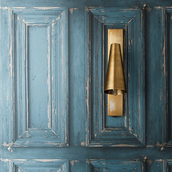 Pooky - Victor Wall Light - Antique Brass mounted on a blue textured wall.