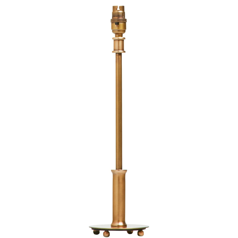 Pooky - Regular Pod Table Lamp Base - Antique Brass resting on four ball feet.