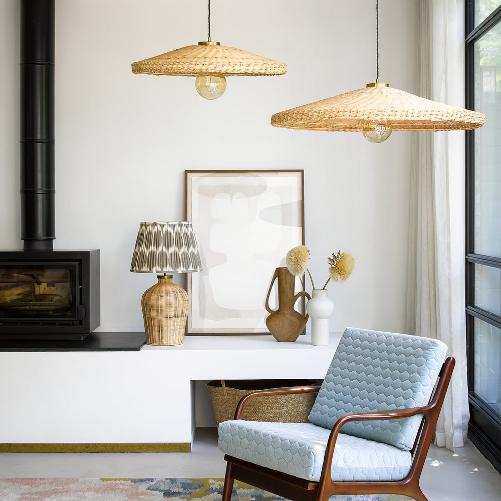 Pooky - Regular Rattle Table Lamp Base - Natural Cane with a patterned shade in a modern living room.
