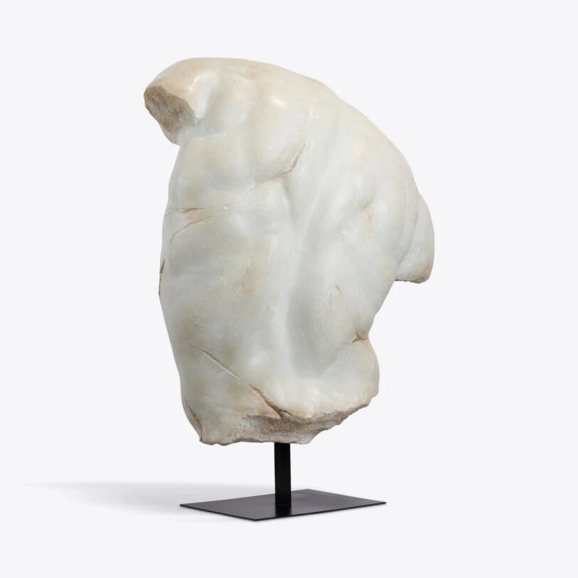 Side view of the Pure White Lines Sirrus XL Male Torso in an aged marble finish, displayed on a black stand.
