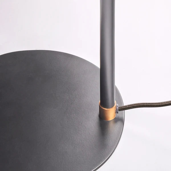 Black base and cord detail of the Pooky - Pick Reading Lamp - Black And Antiqued Brass.