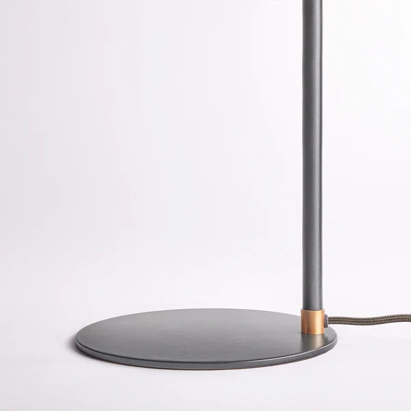 Base and brass detail of the Pooky - Pick Reading Lamp - Black And Antiqued Brass.