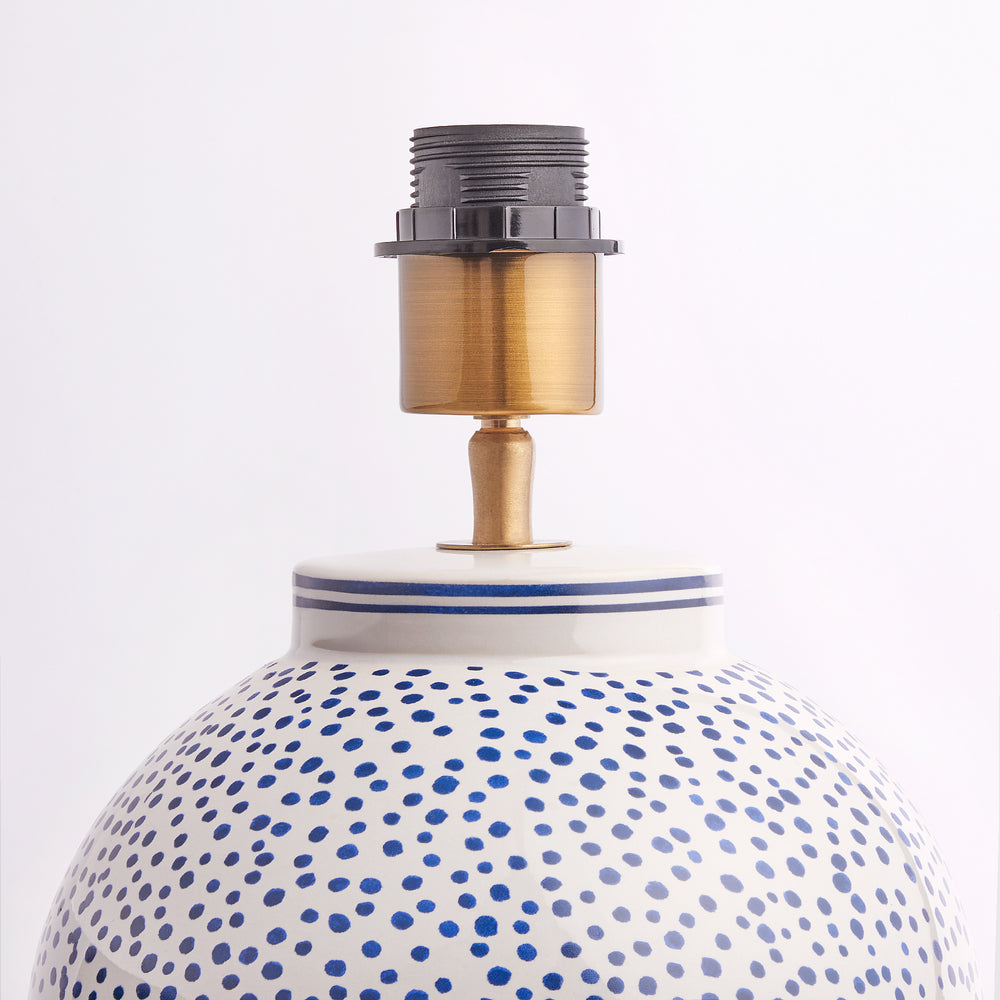 Top detail of the ceramic Pooky - Polka Table Lamp Base - Blue and White with brass bulb fitting.