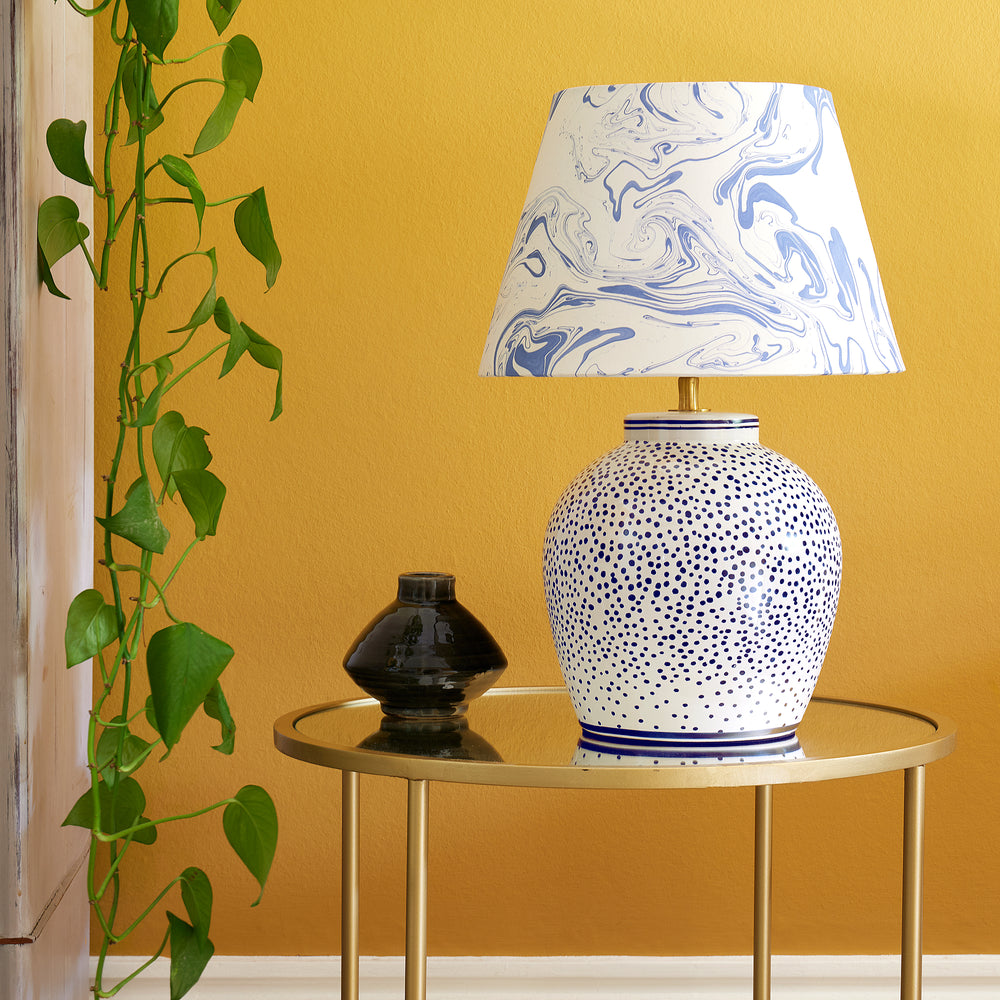 Pooky - Polka Table Lamp Base - Blue and White paired with a marbled shade on a gold table.
