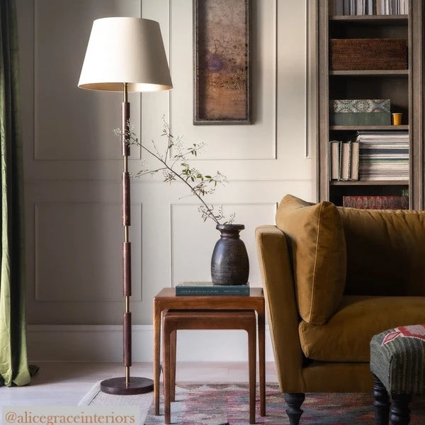 Pooky - Skellig Floor Lamp Base - Burnt Wood And Brass - Without Lampshade next to a velvet sofa