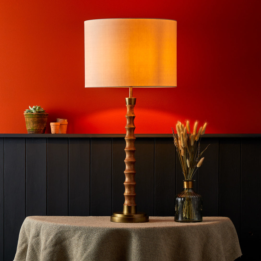 Pooky - Tinto Table Lamp Base - Natural Wood and Antique Brass with a lit shade.